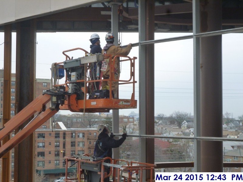 Installing the curtain wall mullions around the Monumental Stair radius Facing South